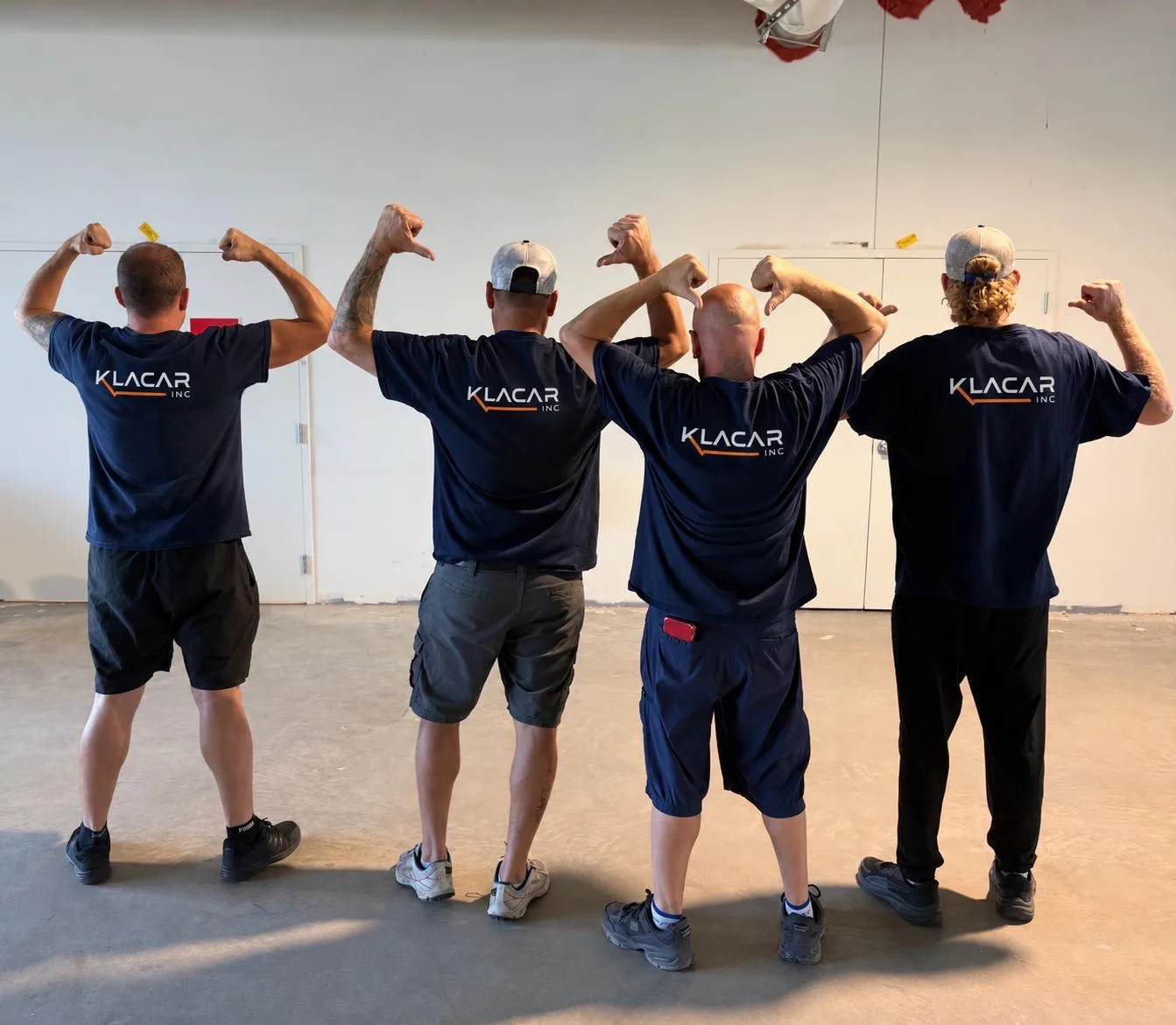 Klacar crew members in company shirts on a move