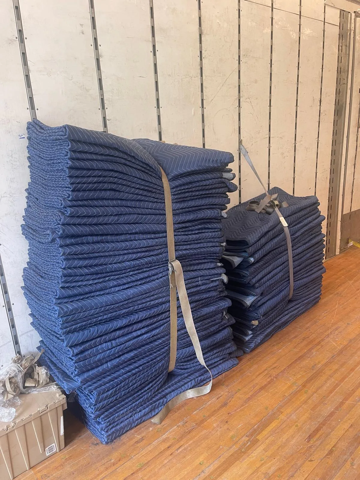 Stacks of moving blankets inside a Klacar truck