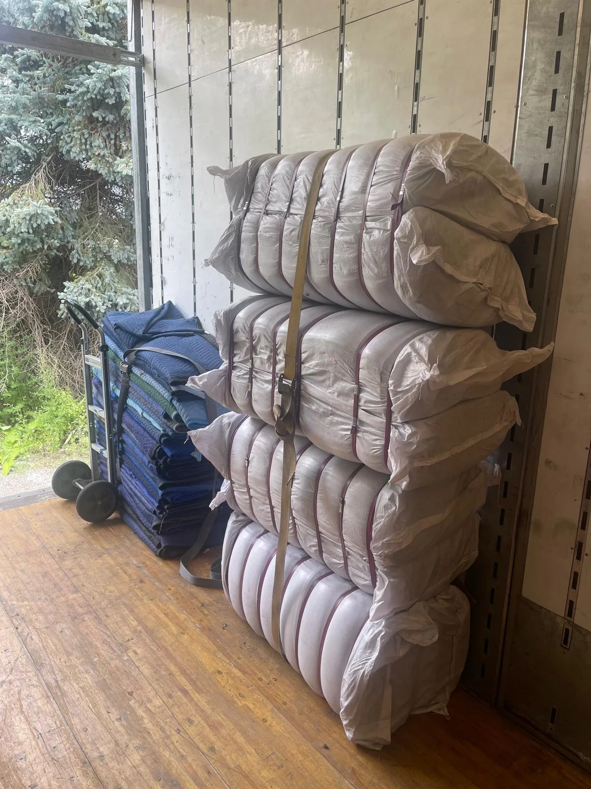 Mattresses wrapped in plastic before loading