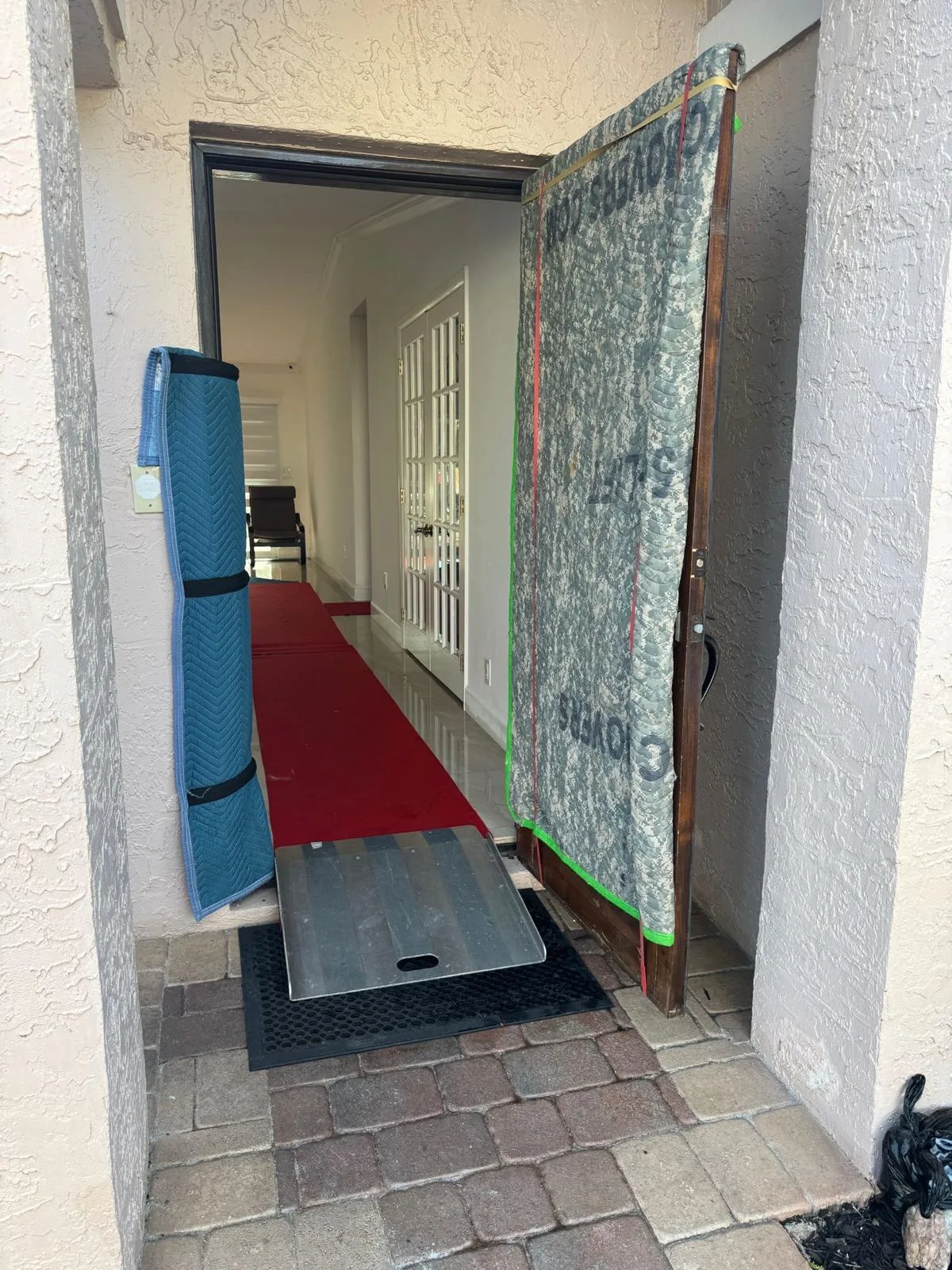 Door-jamb pad and floor runner at a home entrance